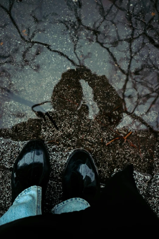 legs are visible with the reflection of two people