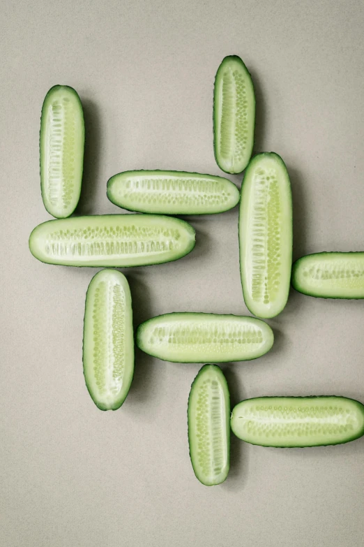 pickles on a grey table and white surface