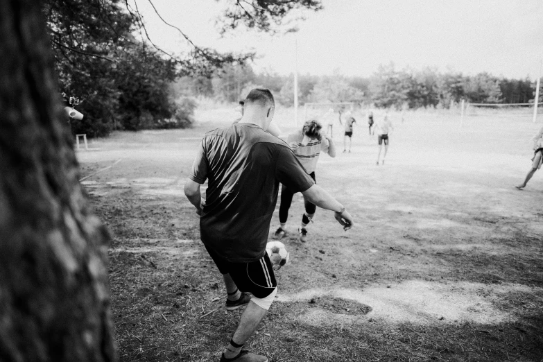 a black and white po shows several s playing soccer