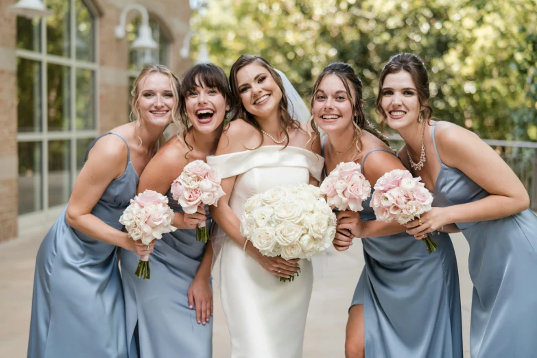 a bride and her four bridals pose for a wedding pograph