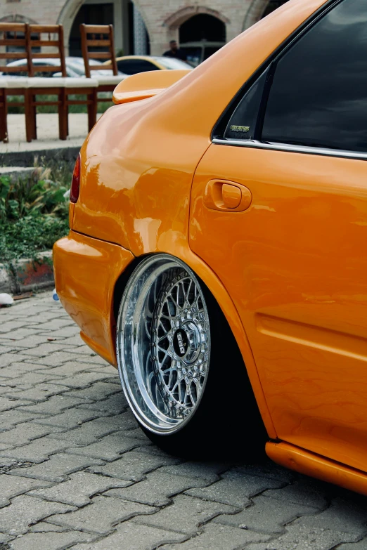 an orange car parked in a parking lot