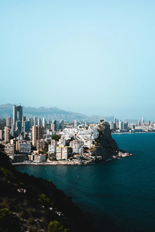 some buildings are on the other side of a large body of water