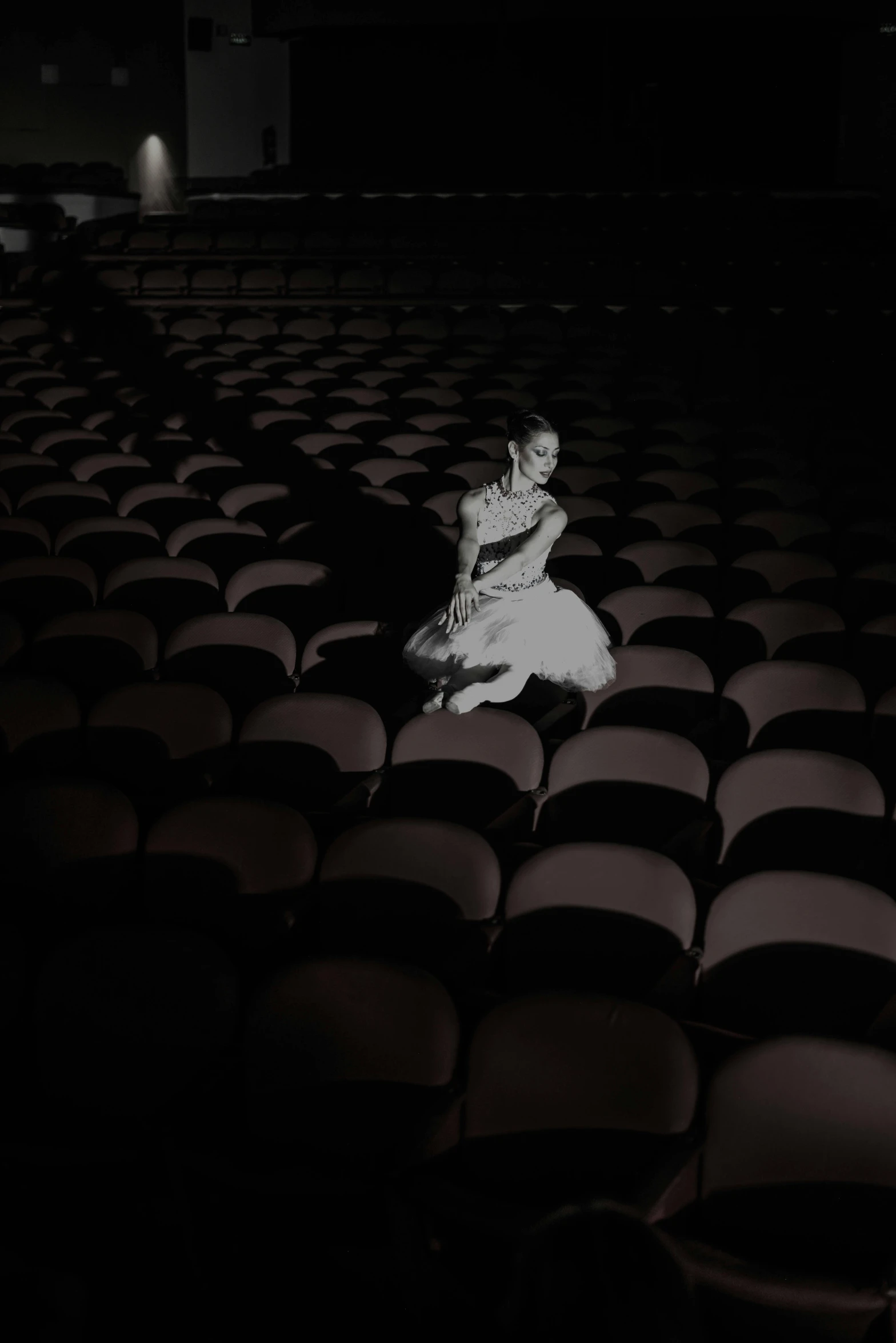 a woman in a white dress standing on chairs