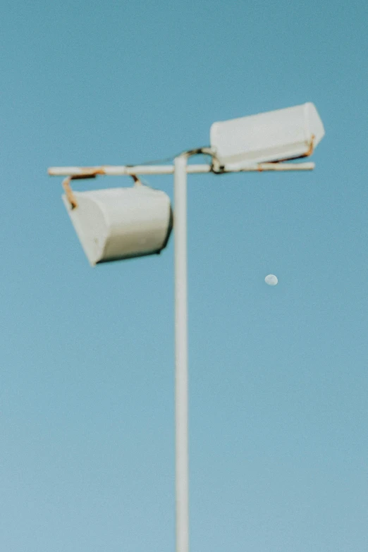 two rolls of toilet paper are hanging from the back of a white pole