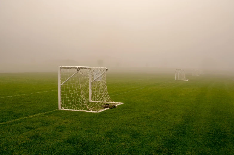 soccer goal on a foggy day with goal post