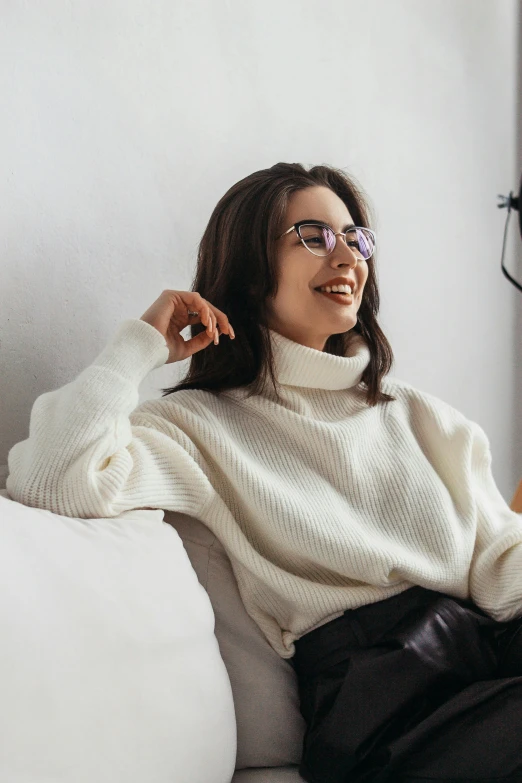 a woman sitting on top of a white couch