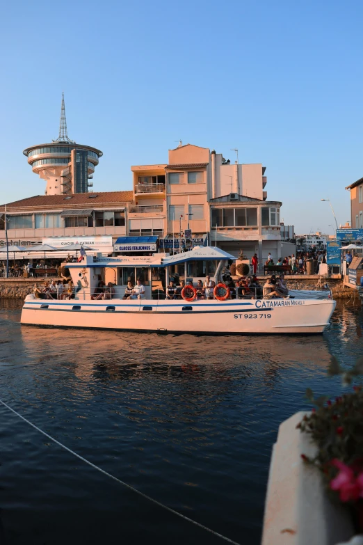 a boat with passengers going down the river