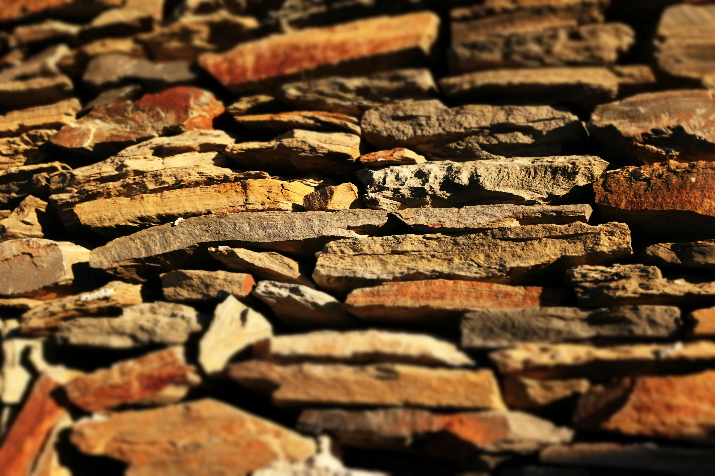 a closeup of small rocks with a red and yellow line across the middle