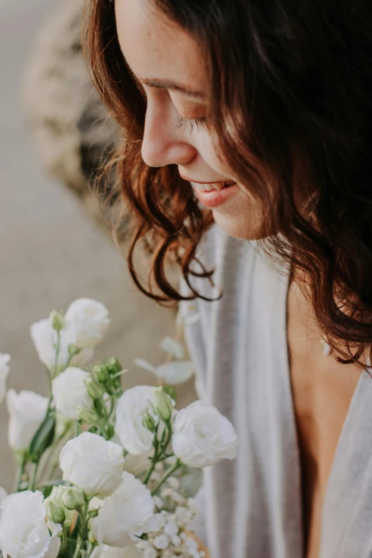 an up close s of a woman holding a bouquet of flowers