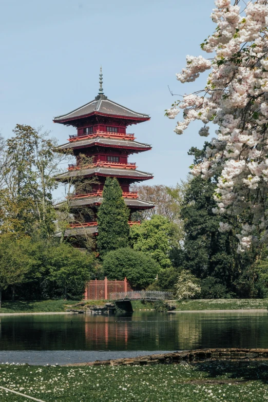 a building stands tall beside water and trees