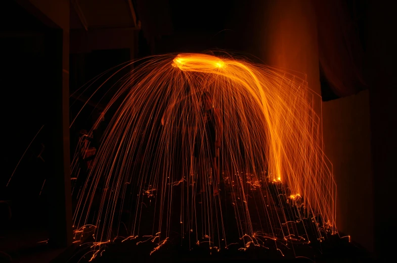 an image of sparks coming from a furnace