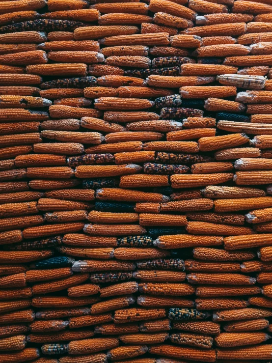 a pile of baby carrots stacked together with different colors