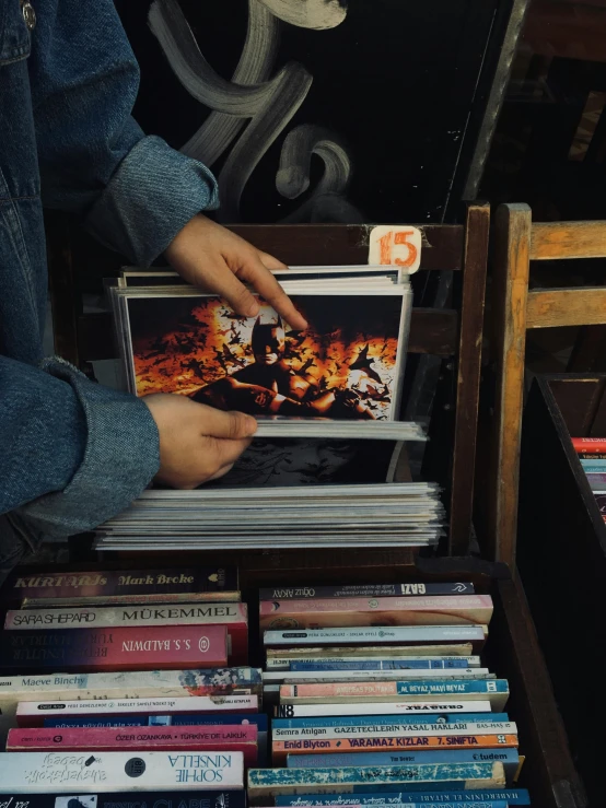 the man is pulling out a book from a pile