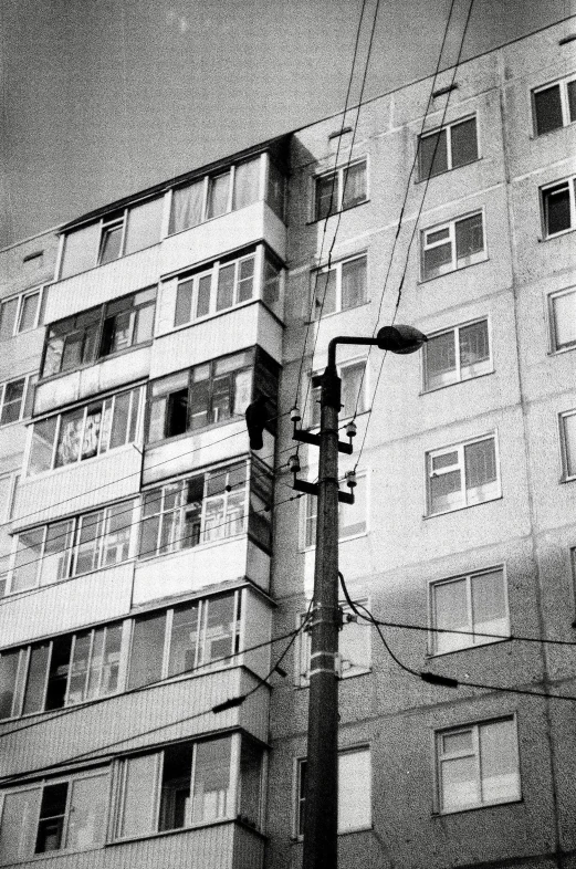 a street lamp with three buildings in the background