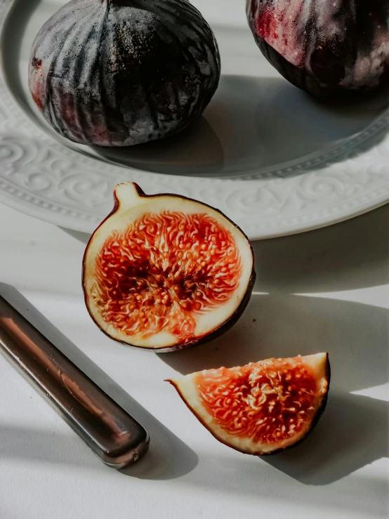 sliced figs and some kind of sauce on a plate