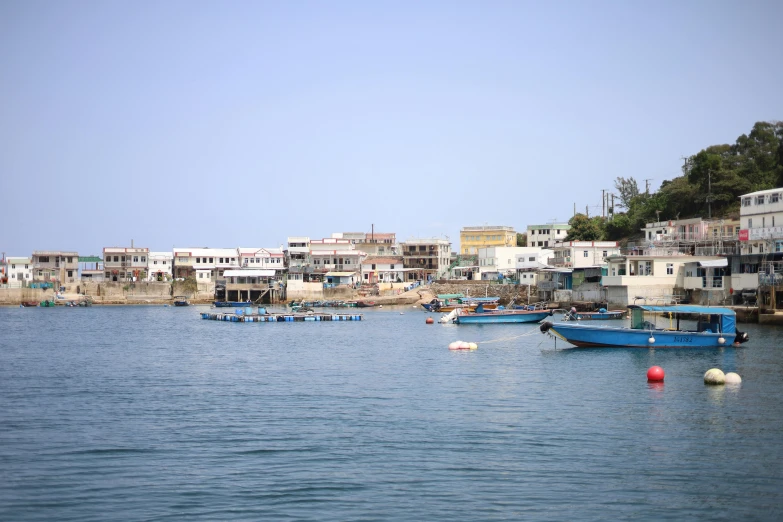 boats are floating on the water next to houses