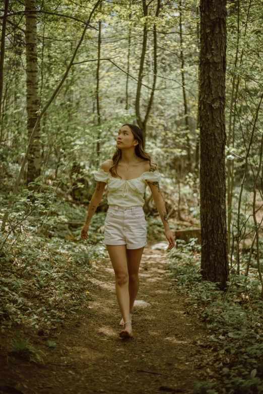 the  in white shorts is walking along a path