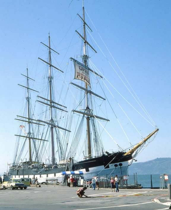 an old sailing ship that is parked at the pier