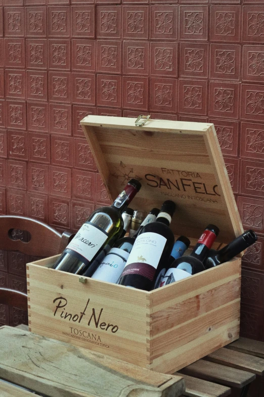 bottles of wine sit inside of a wooden crate