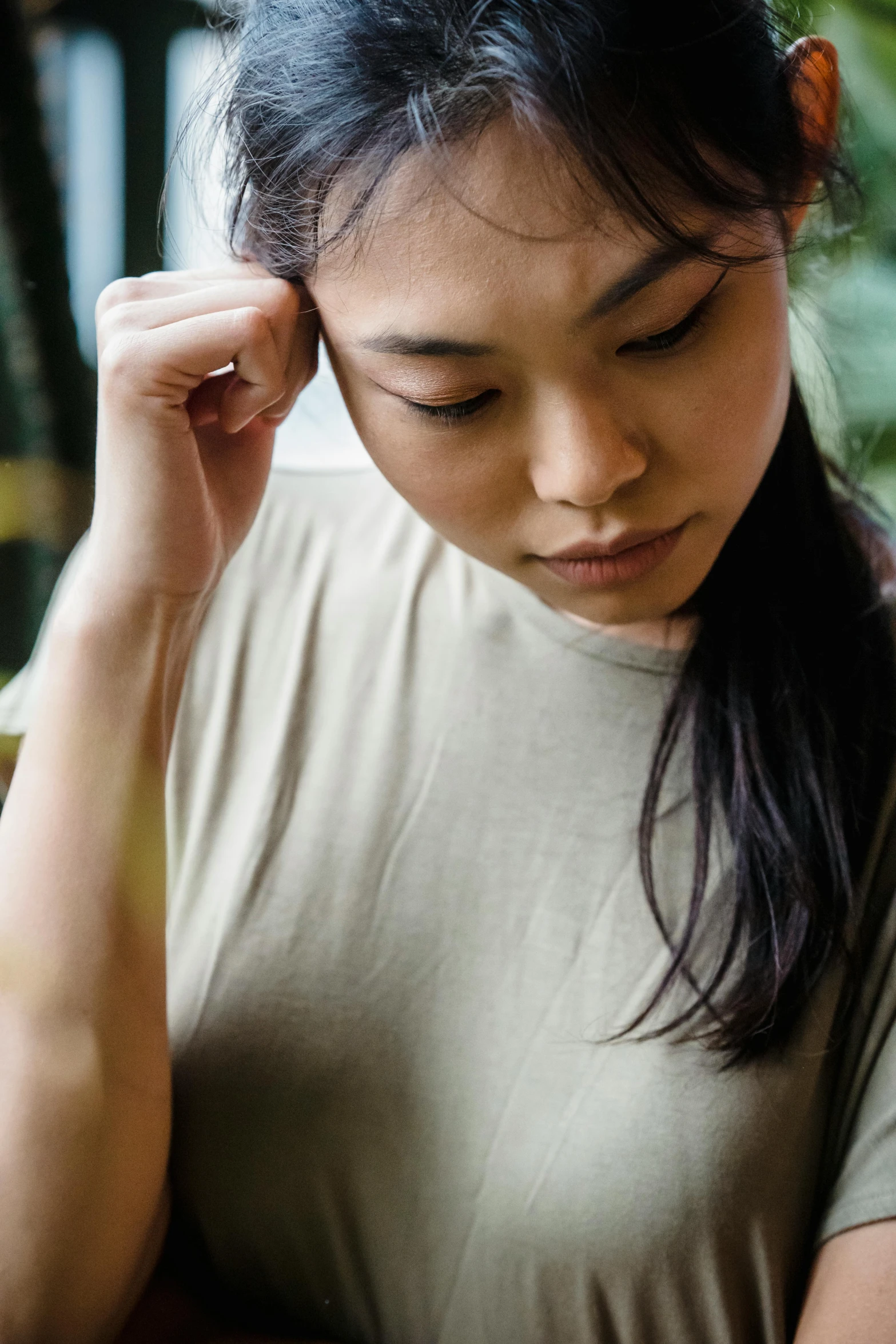 a women looking at her cell phone with eyes closed