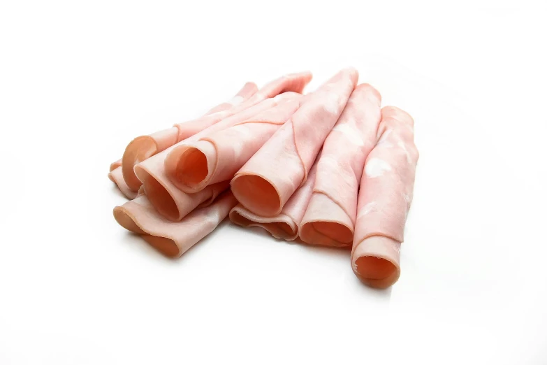 four pieces of raw pork on a white background