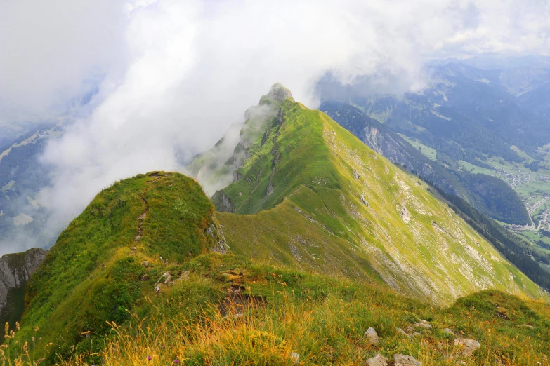 a large hill on the side with grass below