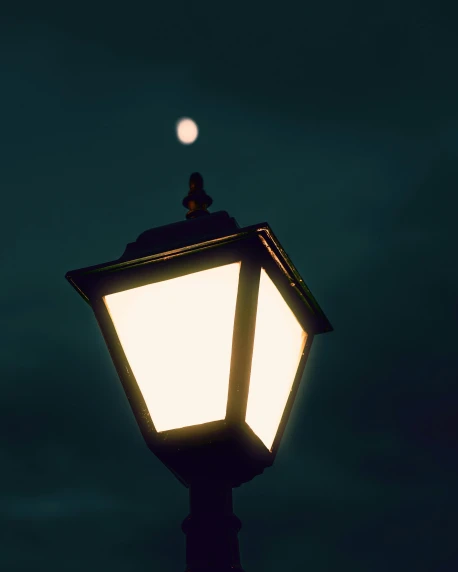 a street lamp lite up at night