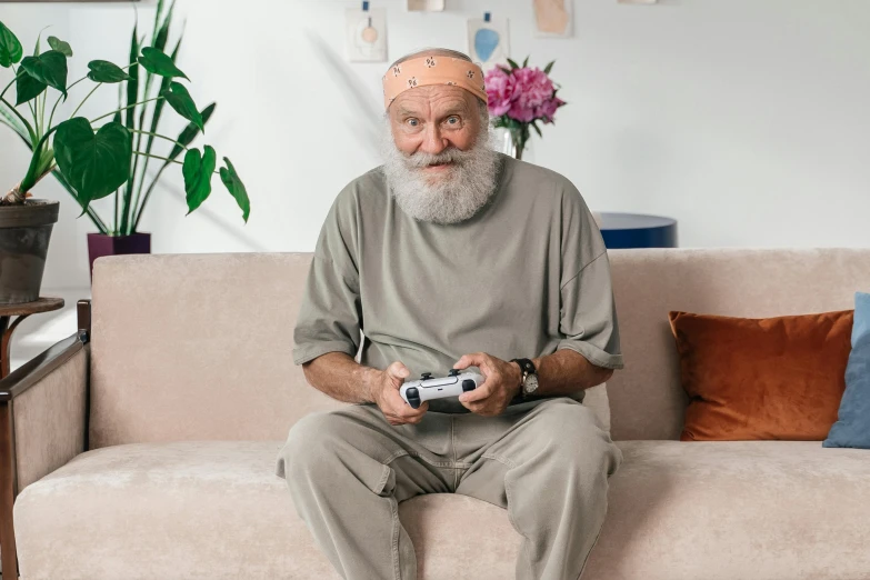a bearded man holding his nintendo wii controller
