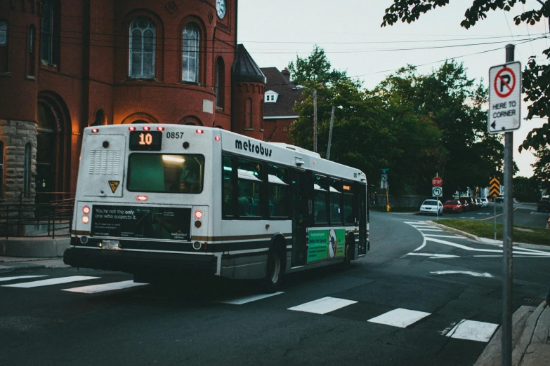 there is a city bus stopped at the bus stop