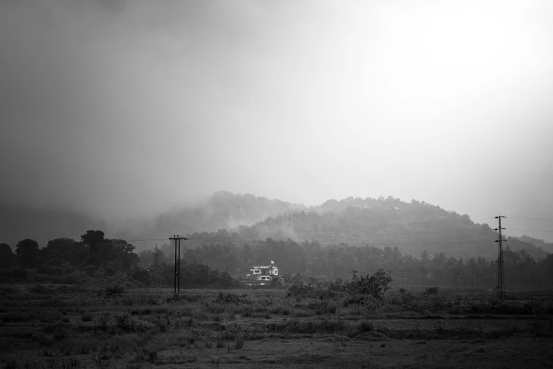 a small house sitting in the middle of a field