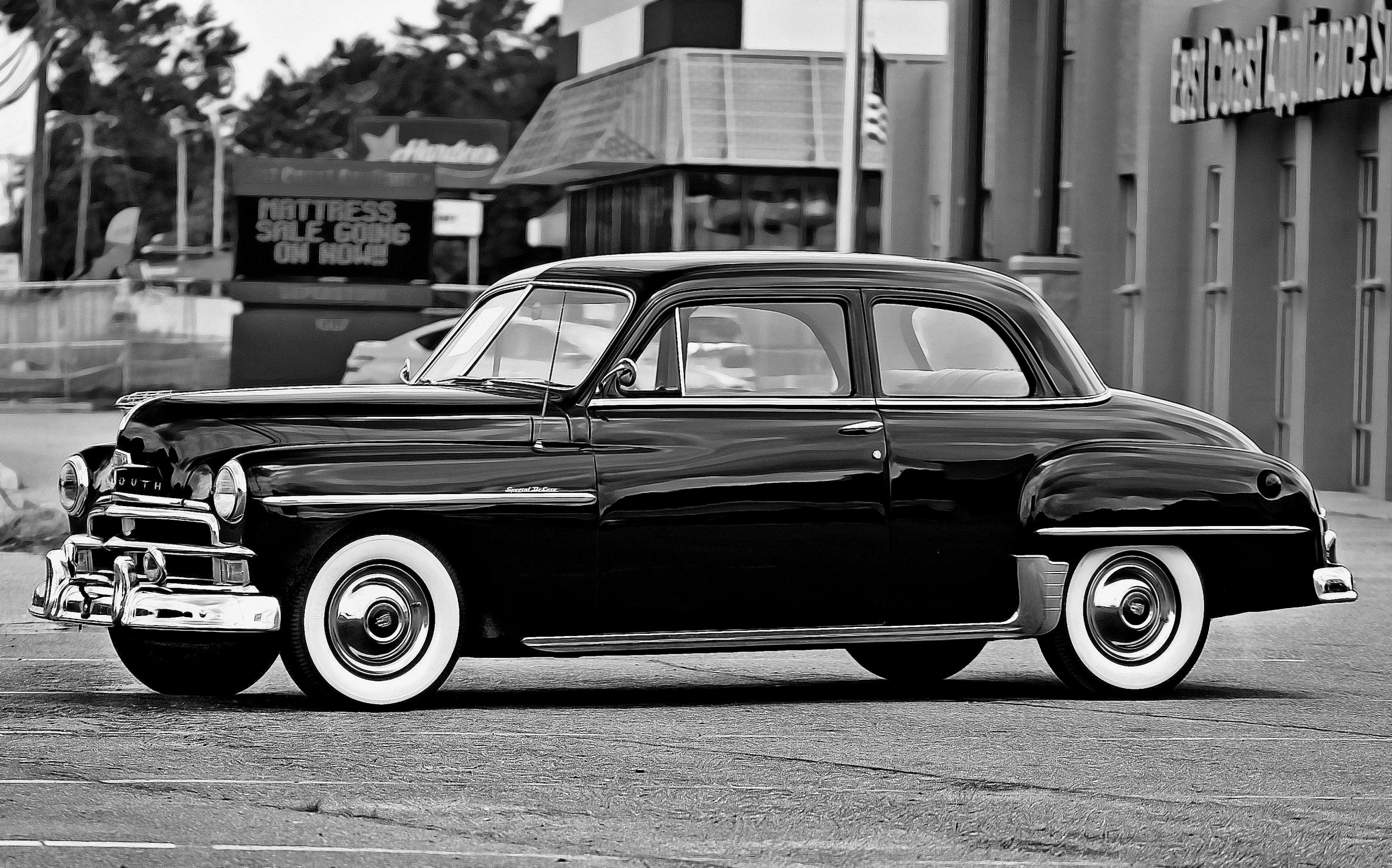 a black and white image of an old car