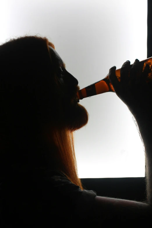 an image of a person being fed with a beer