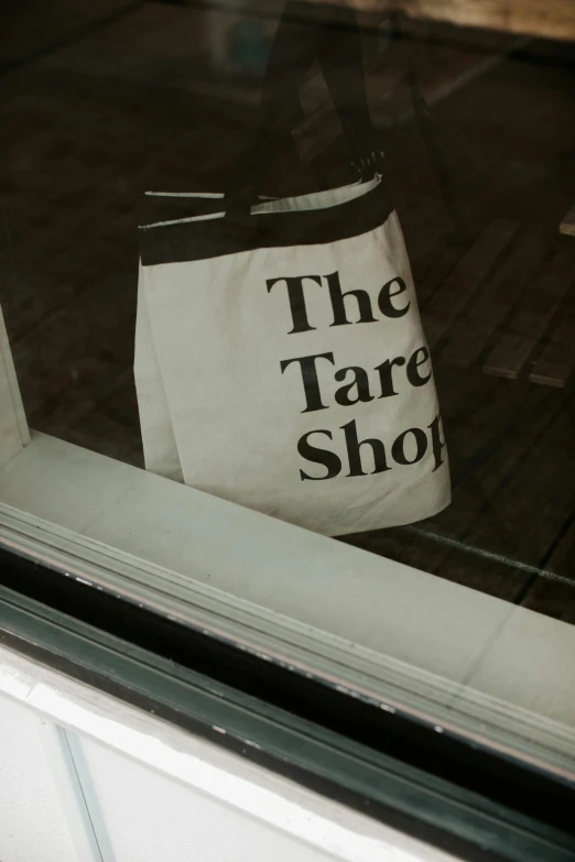 a large white shopping bag is on the storefront window
