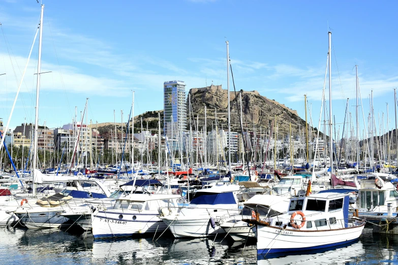 the small boats are tied together in the harbor