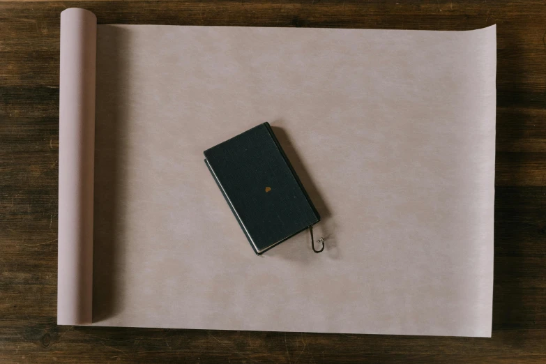 a leather book sitting on top of a wooden table