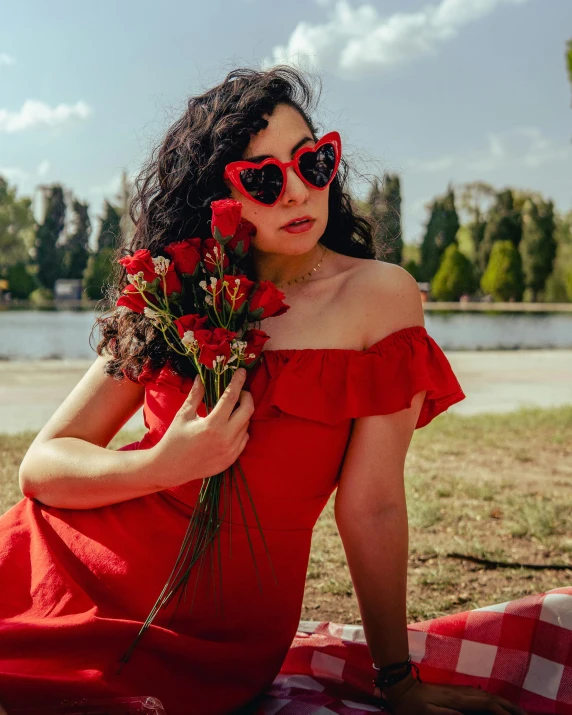 a girl with red glasses is holding some flowers