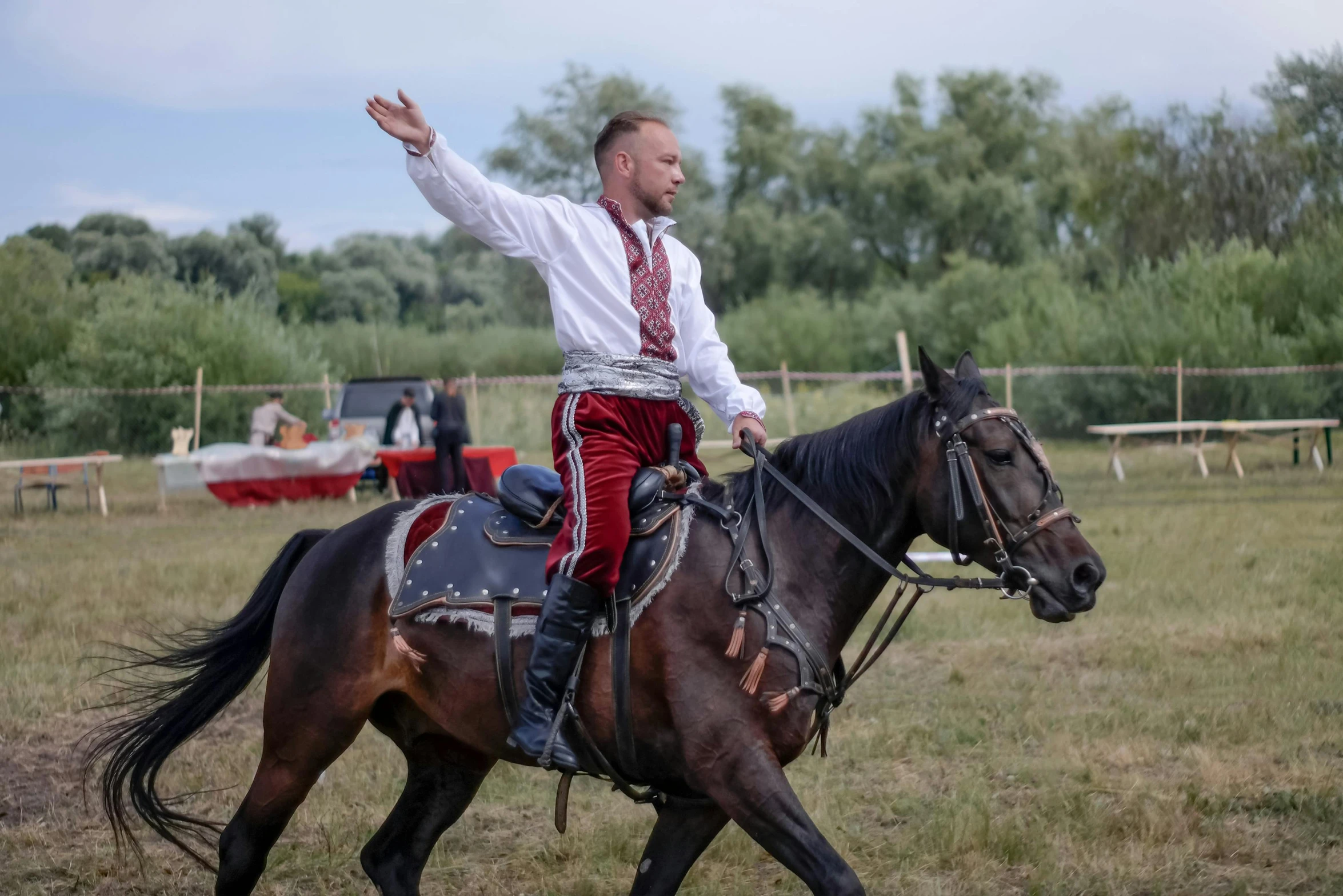 a man dressed in traditional dress riding on the back of a horse