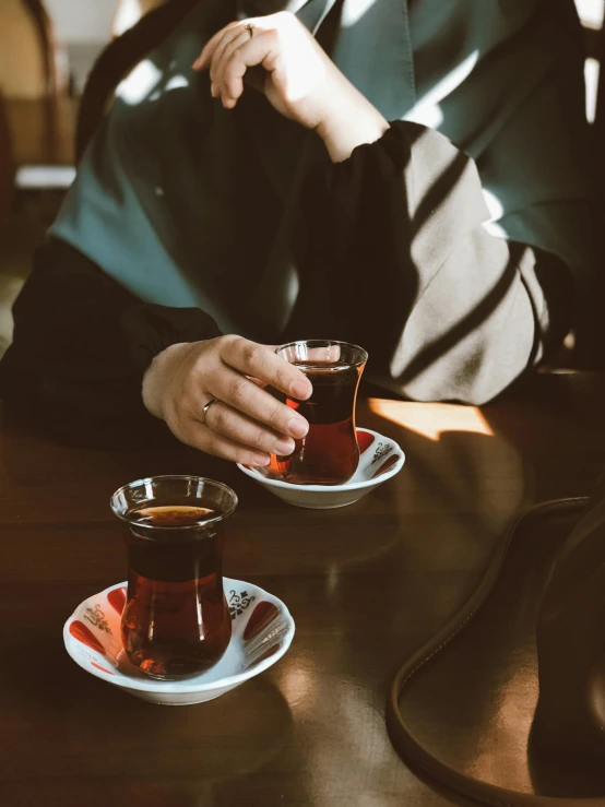 the woman is enjoying her cup of tea