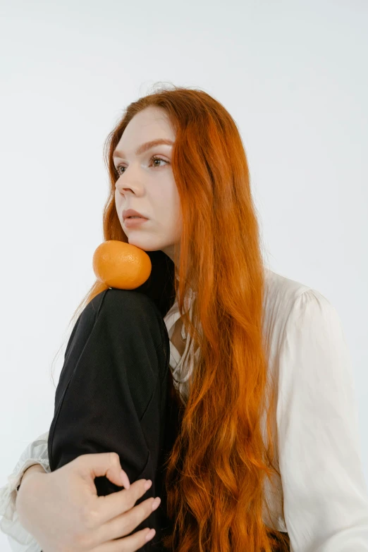 a close up of a woman with a piece of soing in her mouth