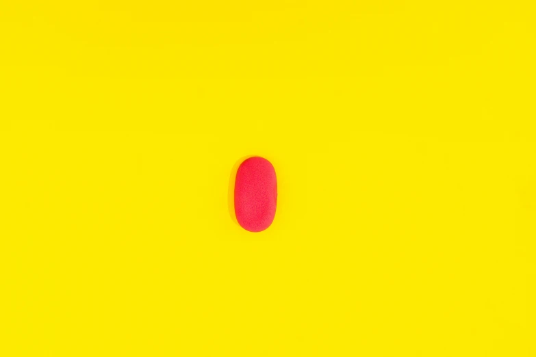 an oval object of some sort on a yellow background