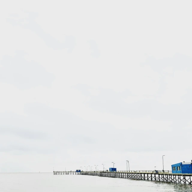 a long pier with many small buildings on it