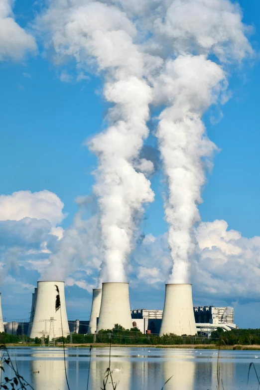 a factory with smokestacks emitting from it's stacks