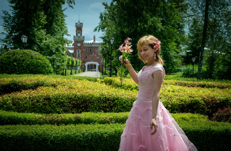 a woman in pink dresses and flower in her hand