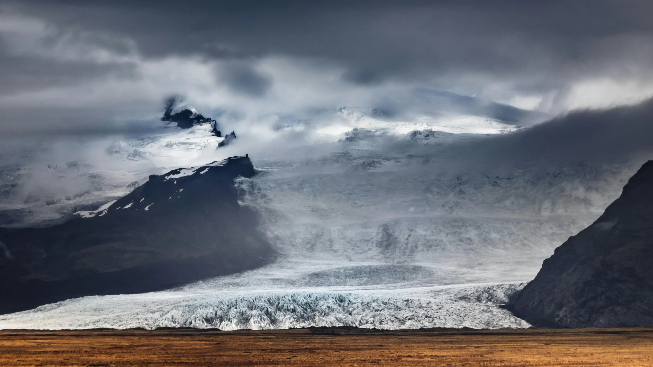 a mountain landscape with snow on top of the mountain