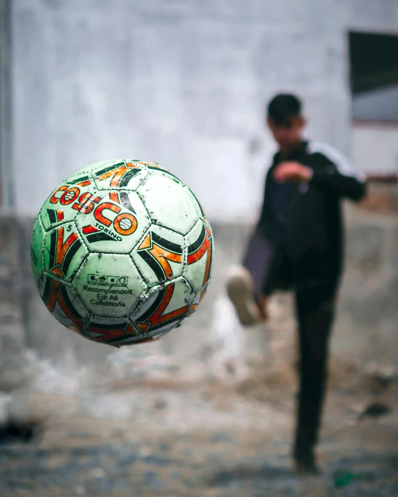 a person throwing a soccer ball up into the air