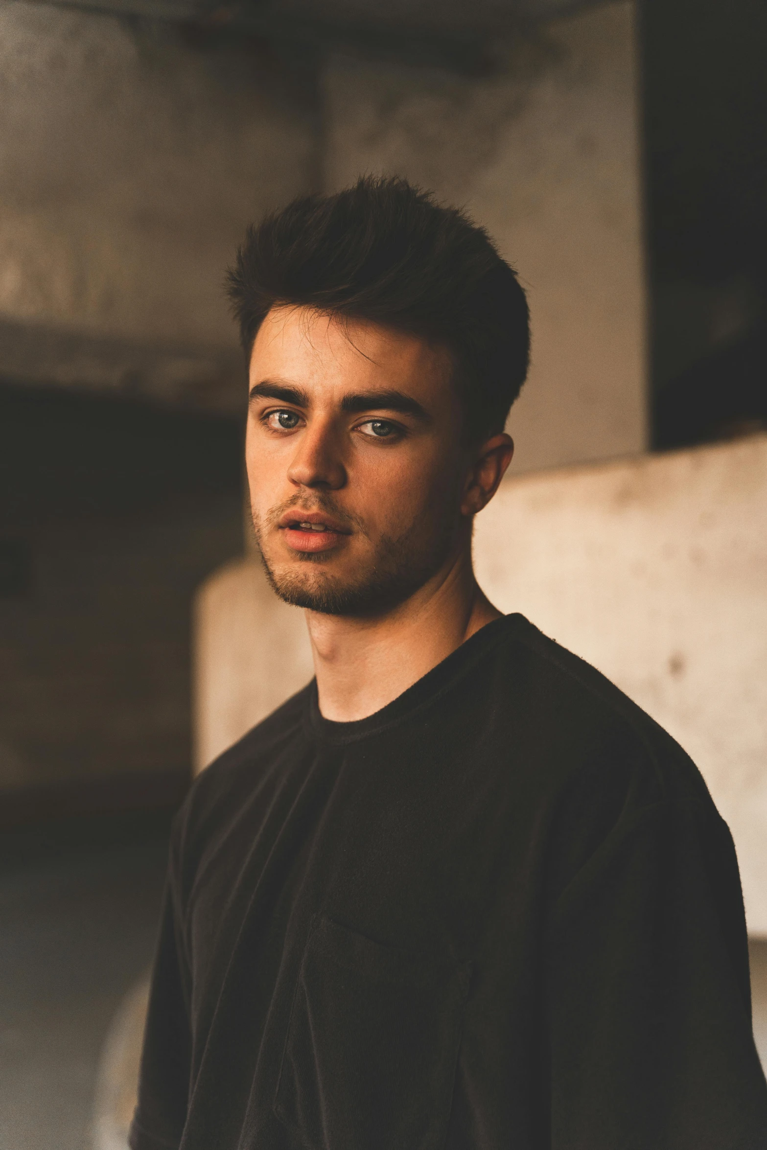 a young man in a black shirt posing for a pograph