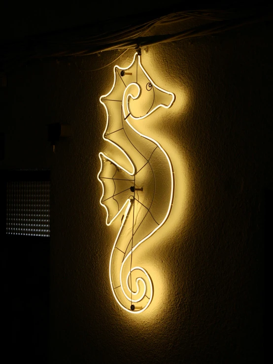 a seahorse light hanging on the wall