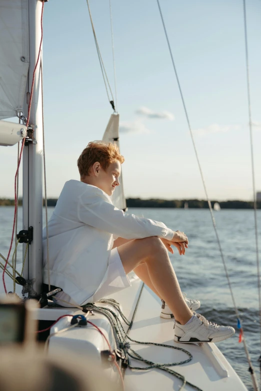 a boy sitting on the deck of a boat