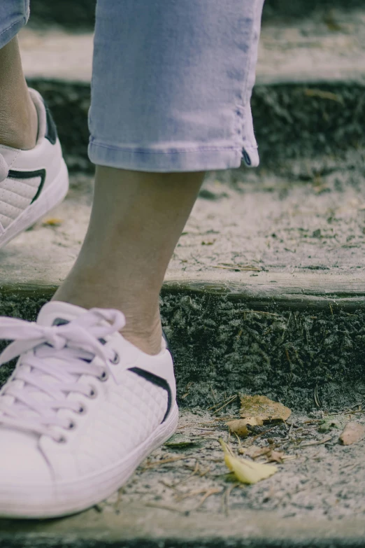 a woman walking up steps with her sneakers on