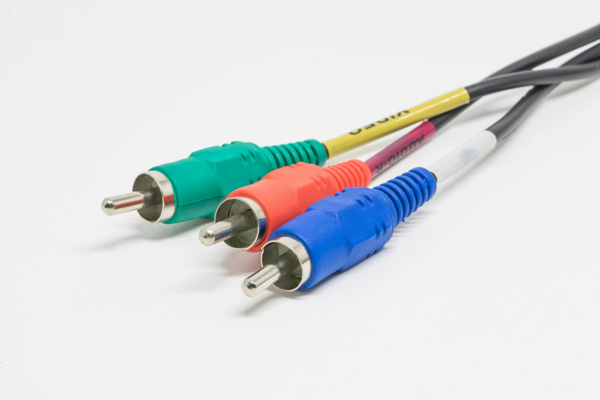 four colorful cables on a white surface in front of each other